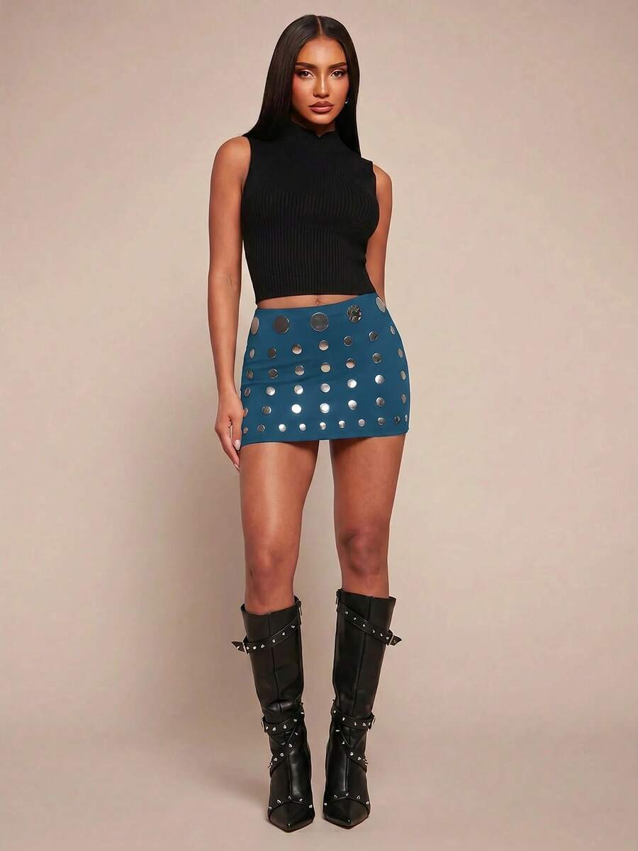 Women's black bodycon mini skort featuring a low waist, pleated side split hem, zipper closure, and built-in shorts.
