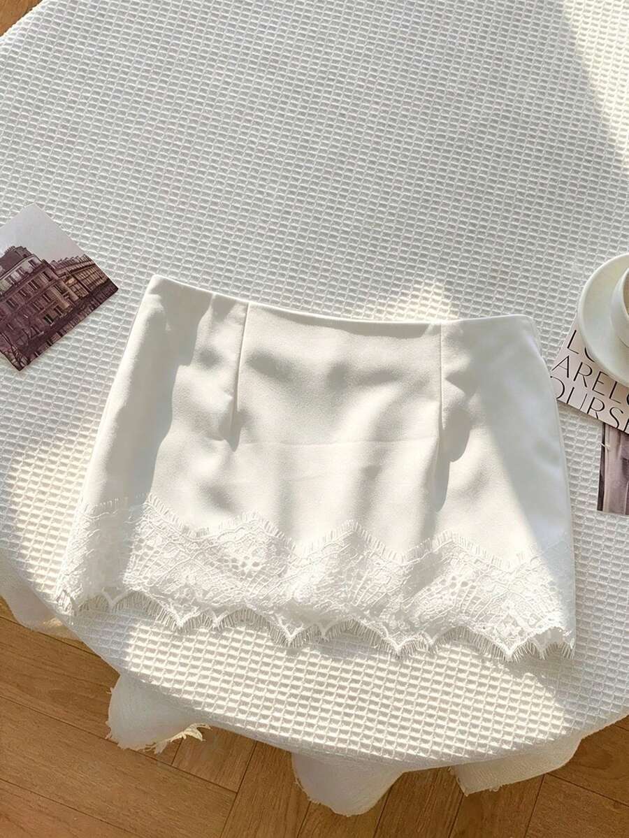 Women's white 100% cotton low waist mini skirt featuring a tropical print and zipper detail.