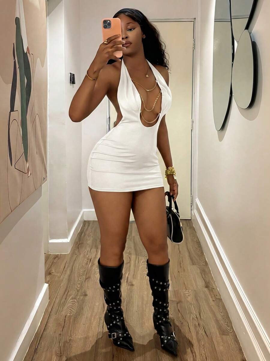 Women's black deep V-neck halter bodycon mini dress featuring a backless design with chain decor detail.