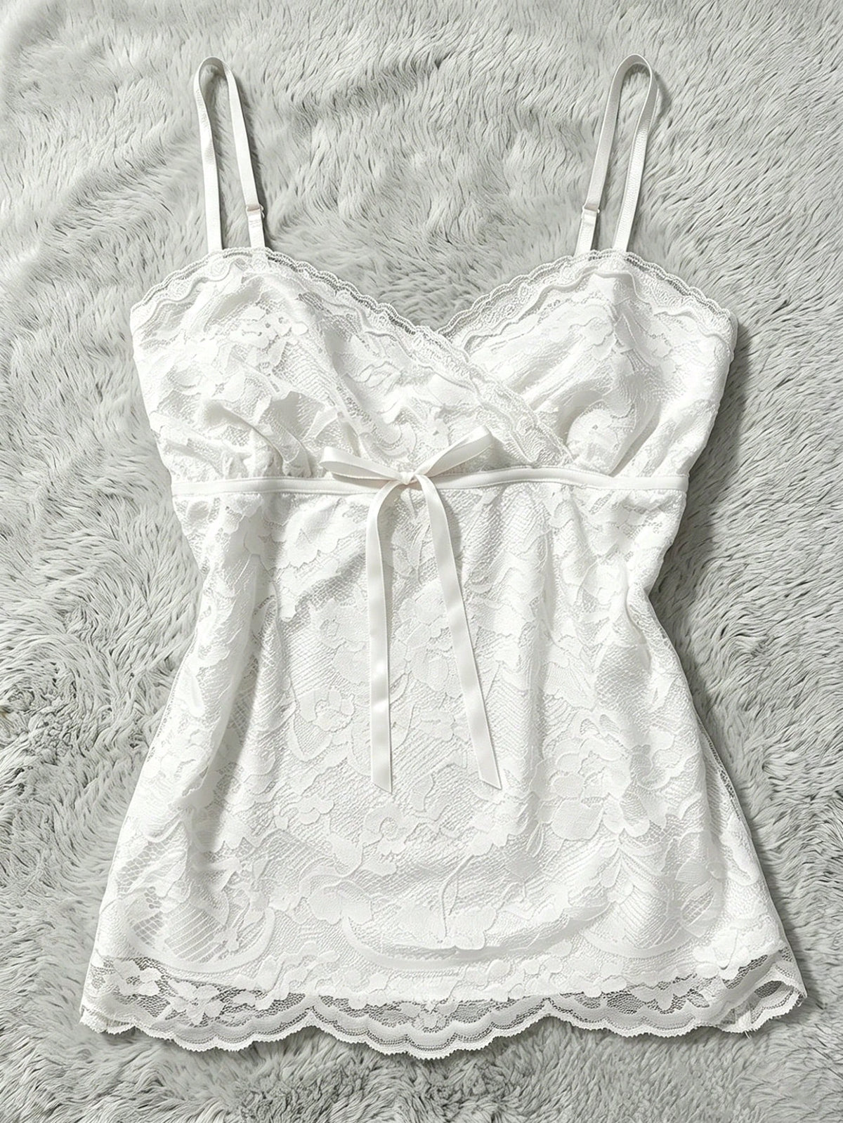Women's solid color elegant lace cami top featuring contrast lace trim, cinched waist, spaghetti straps, and backless ring detail.