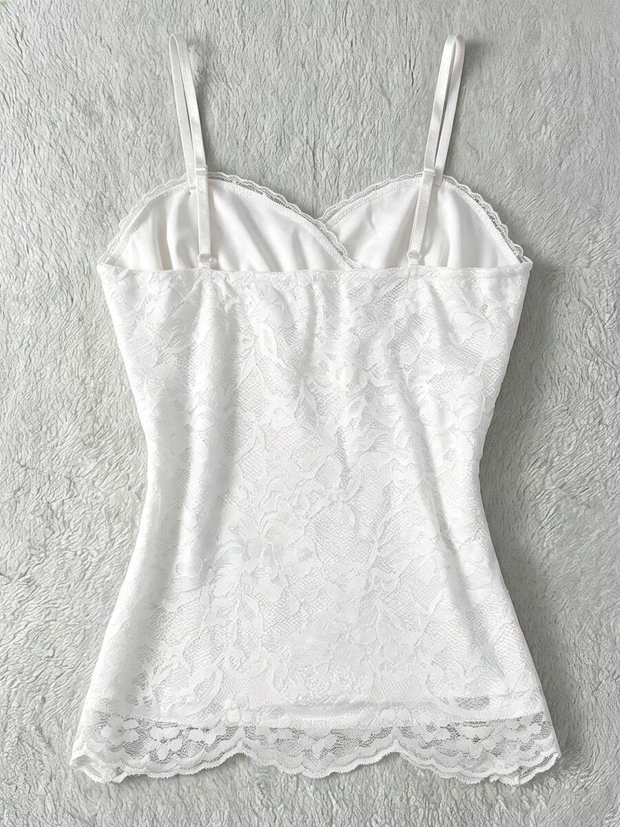 Women's solid color elegant lace cami top featuring contrast lace trim, cinched waist, spaghetti straps, and backless ring detail.