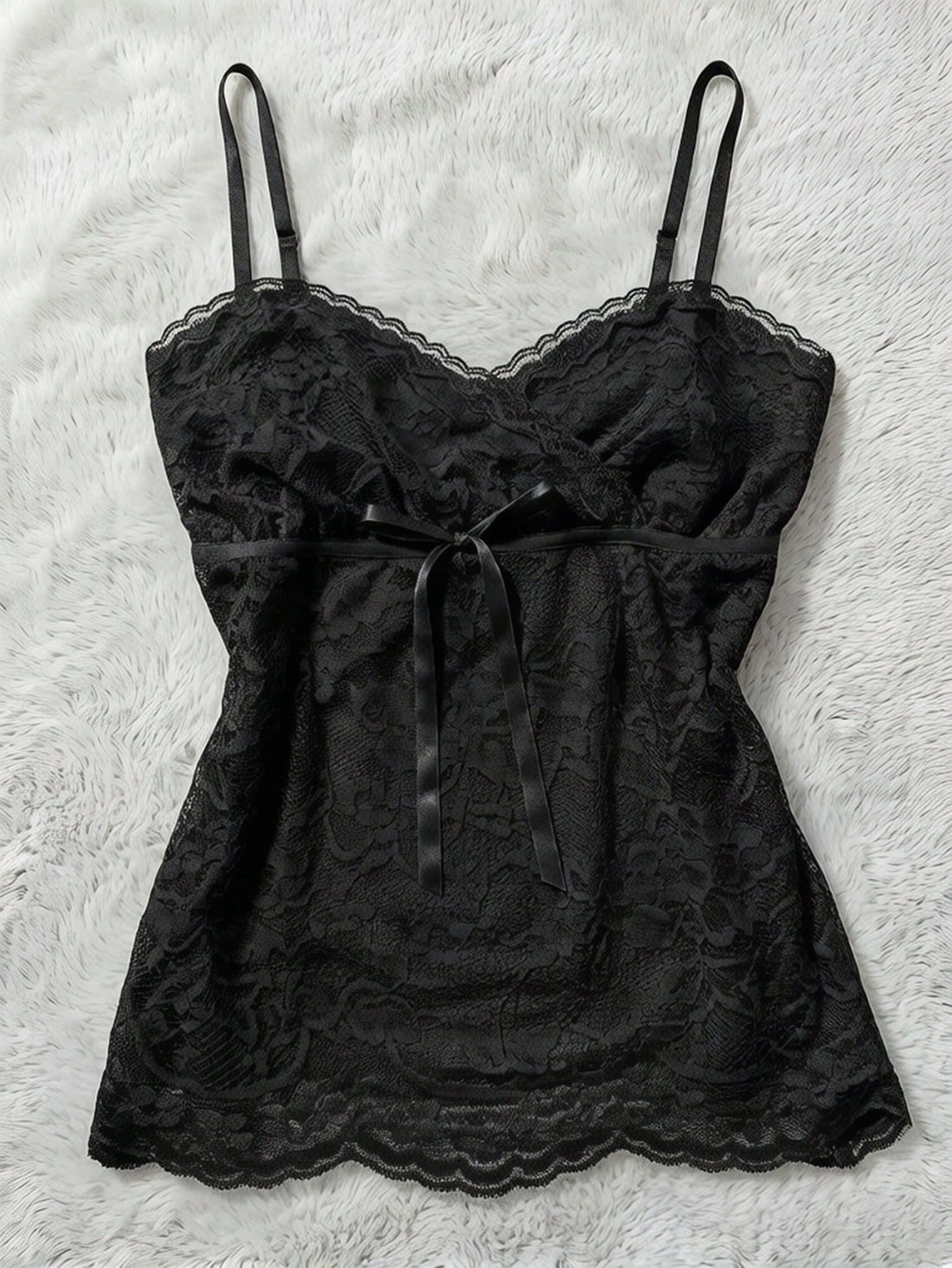 Women's solid color elegant lace cami top featuring contrast lace trim, cinched waist, spaghetti straps, and backless ring detail.