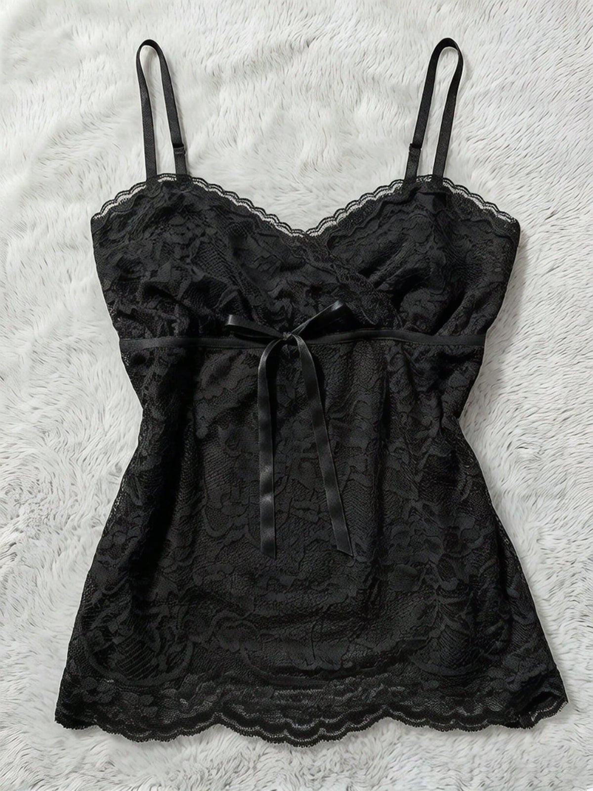 Women's solid color elegant lace cami top featuring contrast lace trim, cinched waist, spaghetti straps, and backless ring detail.