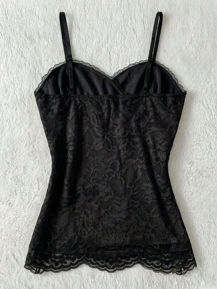 Women's solid color elegant lace cami top featuring contrast lace trim, cinched waist, spaghetti straps, and backless ring detail.