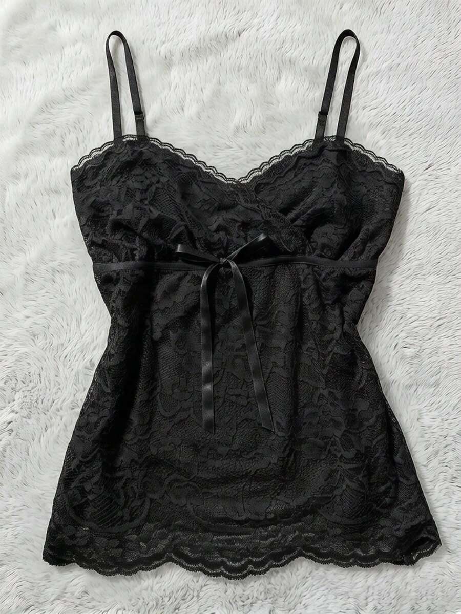 Women's solid color elegant lace cami top featuring contrast lace trim, cinched waist, spaghetti straps, and backless ring detail.