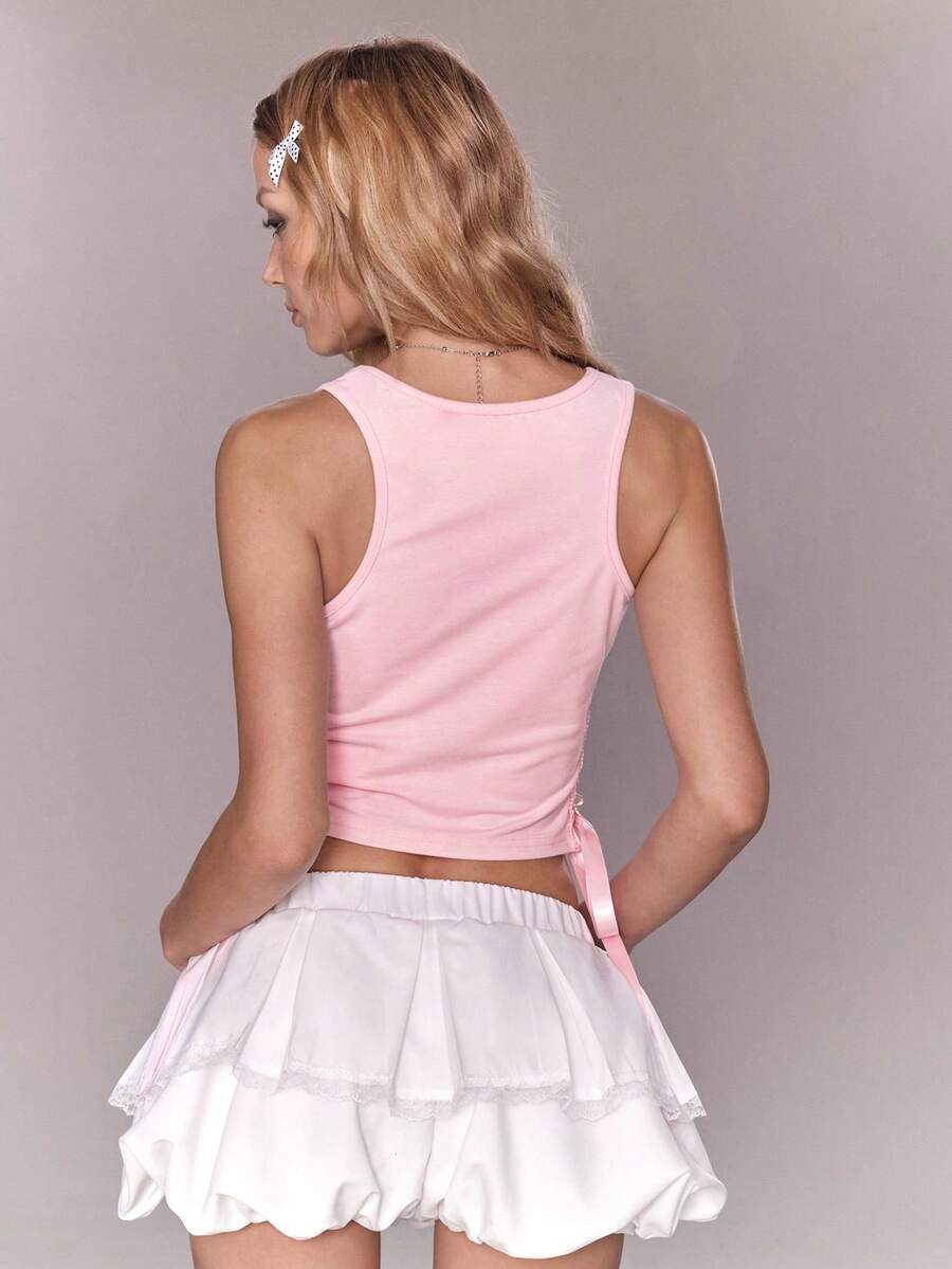 Pink slim fit cropped tank top with scoop neckline, featuring cute rabbit and heart print, rhinestone details, and front ribbon bow accent.