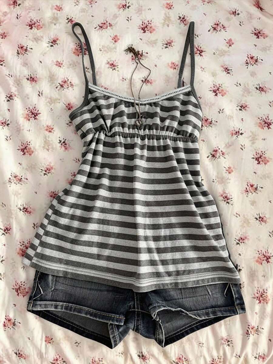 A women's black striped camisole top featuring spaghetti straps, a backless design with ring detail, and high-stretch knitted fabric.