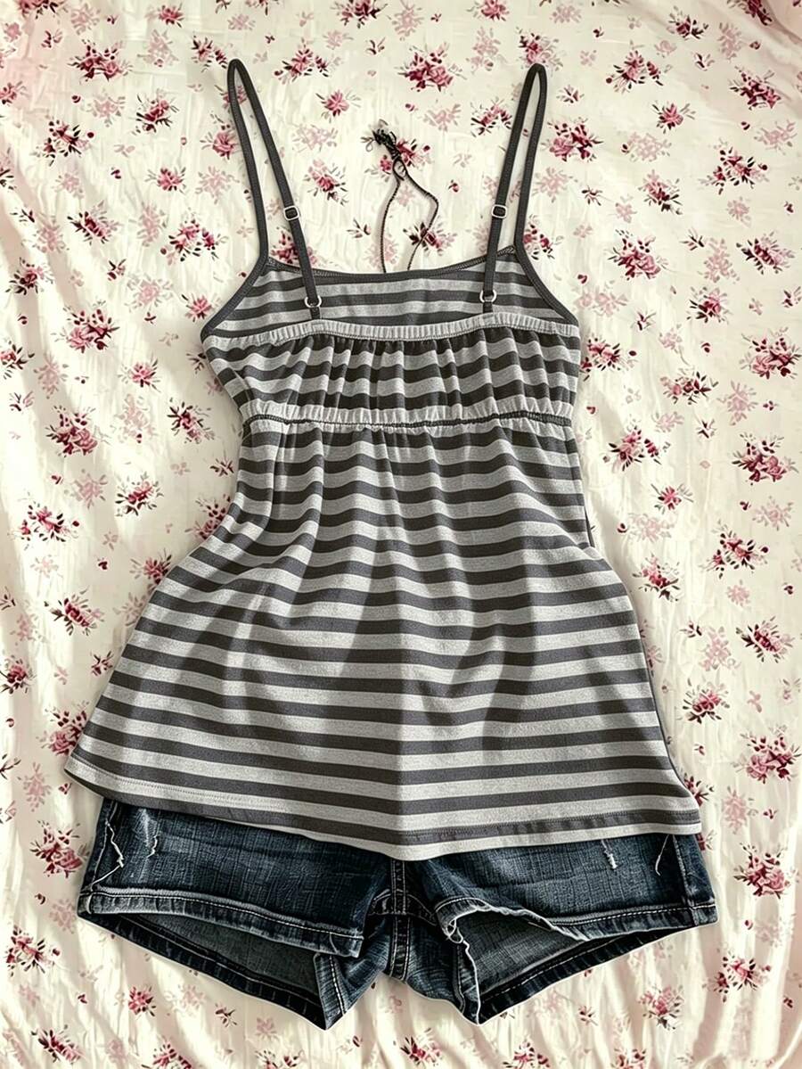 A women's black striped camisole top featuring spaghetti straps, a backless design with ring detail, and high-stretch knitted fabric.