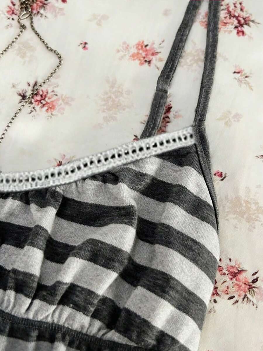 A women's black striped camisole top featuring spaghetti straps, a backless design with ring detail, and high-stretch knitted fabric.
