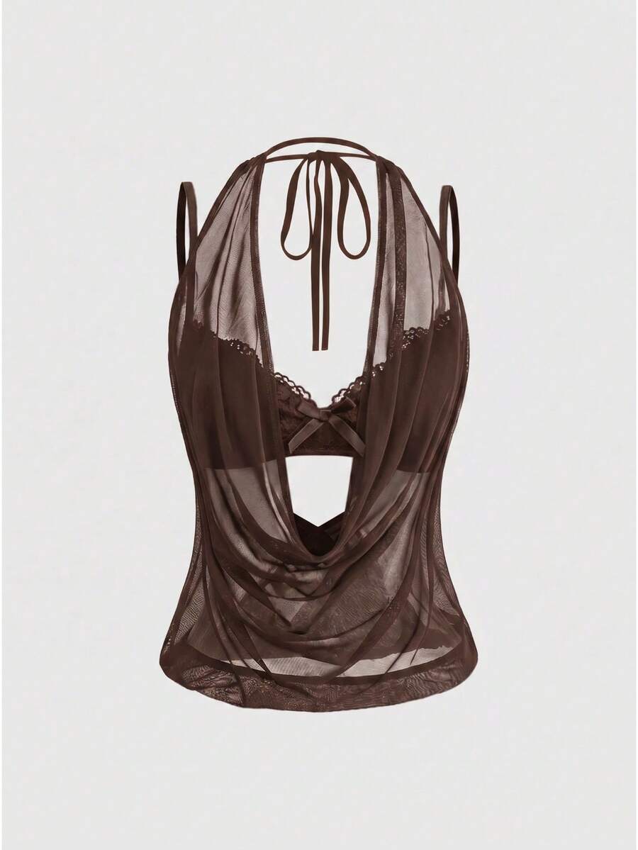 Women wearing a black draped backless halter crop top layered over a boned lace camisole.