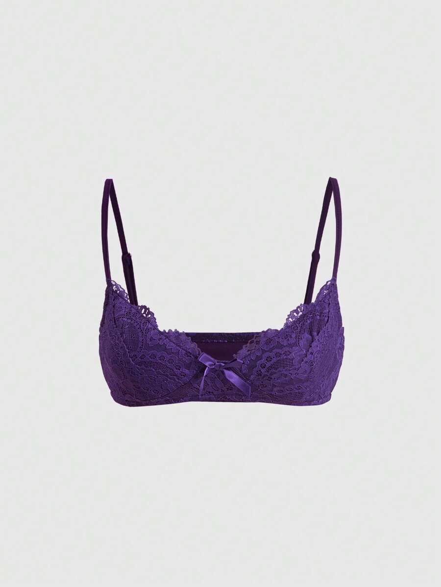 Women wearing a black draped backless halter crop top layered over a boned lace camisole.