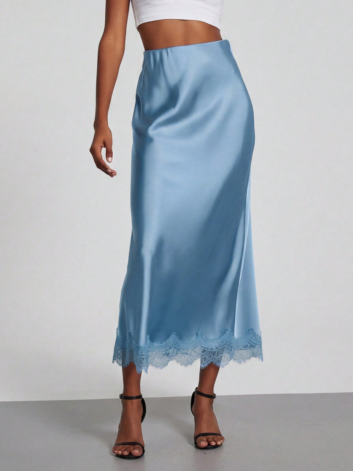 Women's black lace patchwork satin skirt featuring a long bodycon silhouette and natural mid waist design.