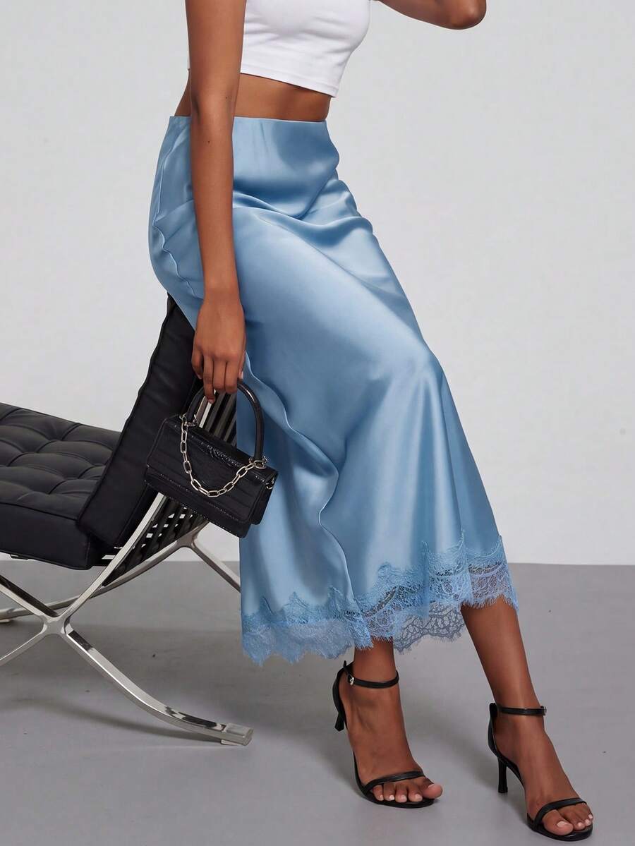 Women's black lace patchwork satin skirt featuring a long bodycon silhouette and natural mid waist design.