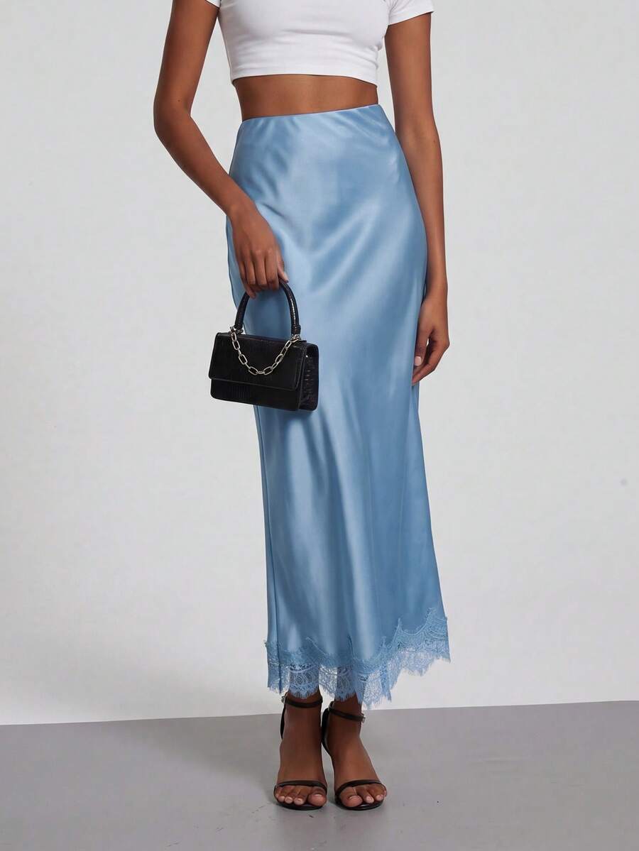 Women's black lace patchwork satin skirt featuring a long bodycon silhouette and natural mid waist design.