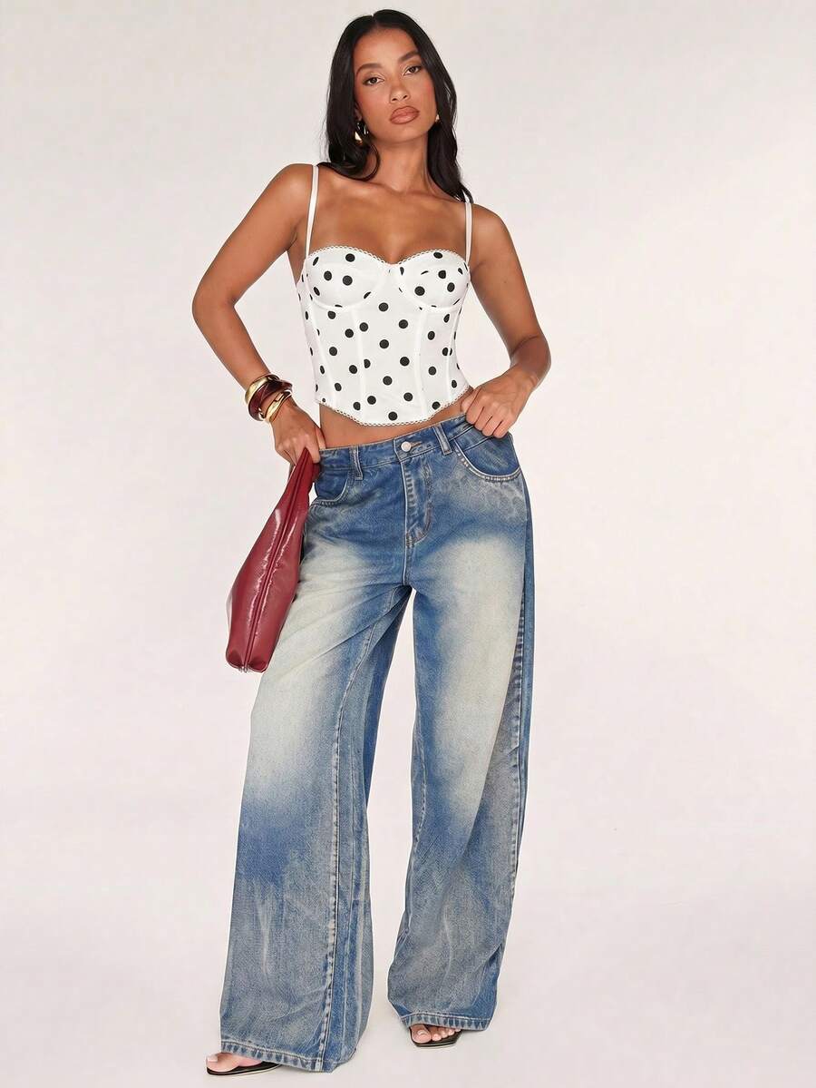 Black women’s lace cami top with spaghetti straps, contrast lace details, and an asymmetrical hem, styled as a slim-fit lined casual top.