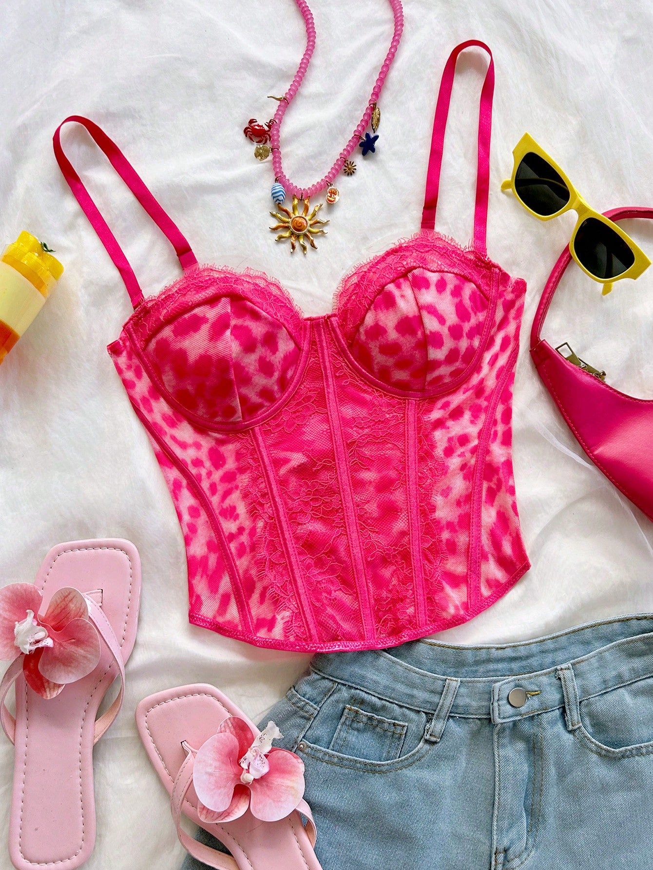 Women's lace bustier camisole top with spaghetti straps, contrast lace, lace-up detail, and an asymmetrical hem in a slim fit design.