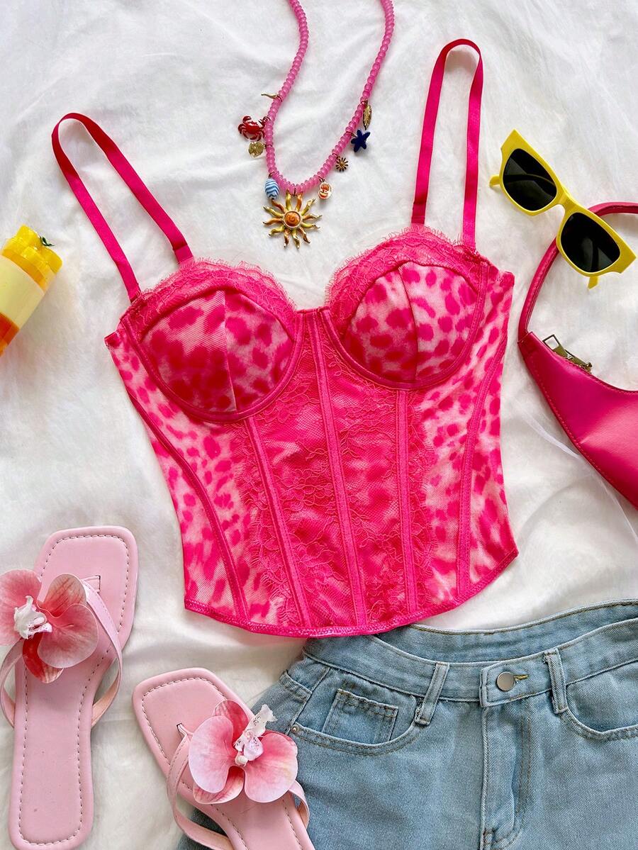 Women's lace bustier camisole top with spaghetti straps, contrast lace, lace-up detail, and an asymmetrical hem in a slim fit design.