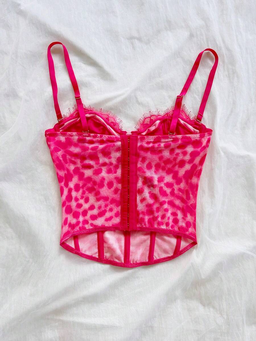 Women's lace bustier camisole top with spaghetti straps, contrast lace, lace-up detail, and an asymmetrical hem in a slim fit design.