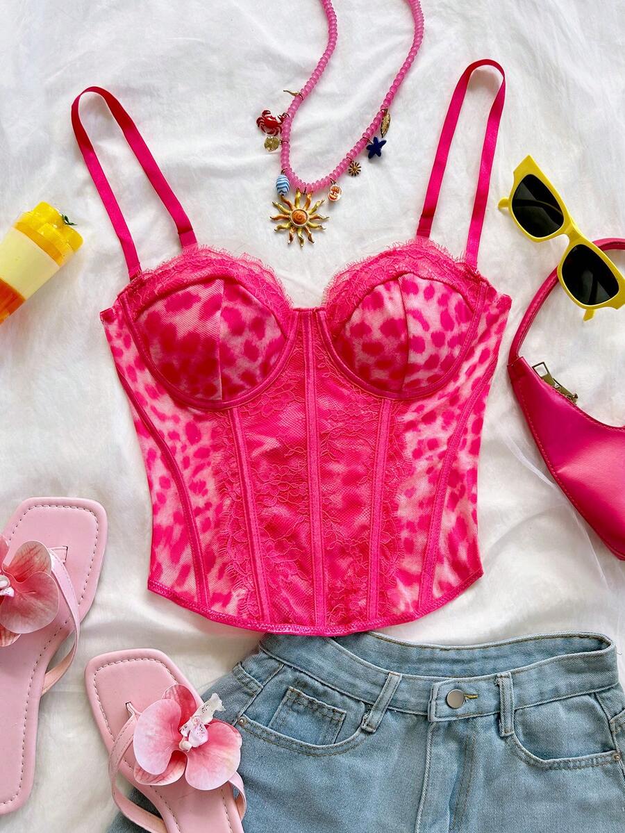 Women's lace bustier camisole top with spaghetti straps, contrast lace, lace-up detail, and an asymmetrical hem in a slim fit design.