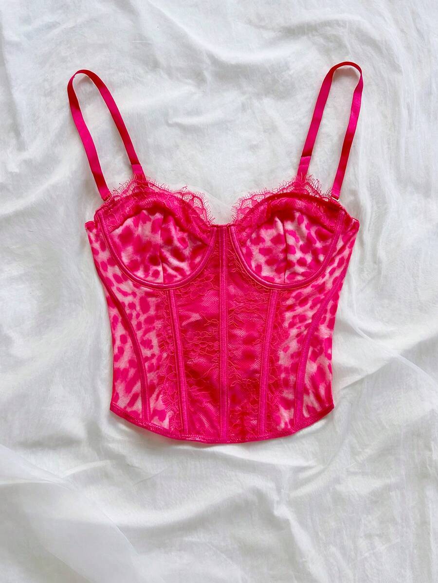 Women's lace bustier camisole top with spaghetti straps, contrast lace, lace-up detail, and an asymmetrical hem in a slim fit design.