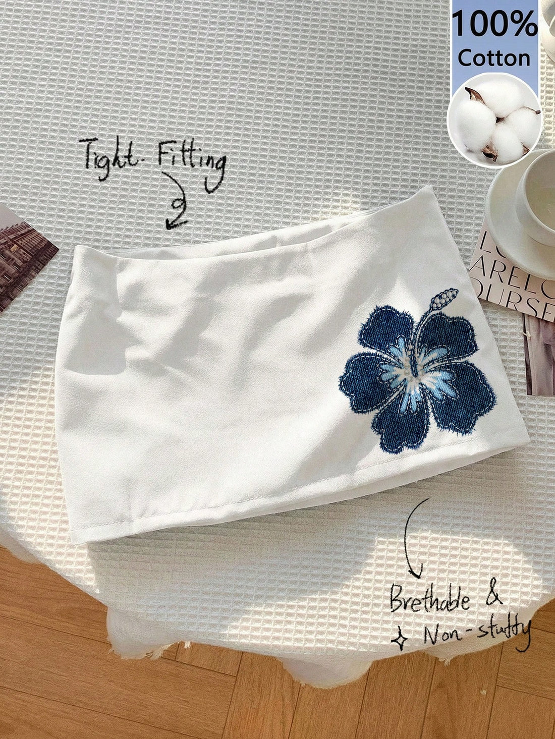Women's white 100% cotton low waist mini skirt featuring a tropical print and zipper detail.
