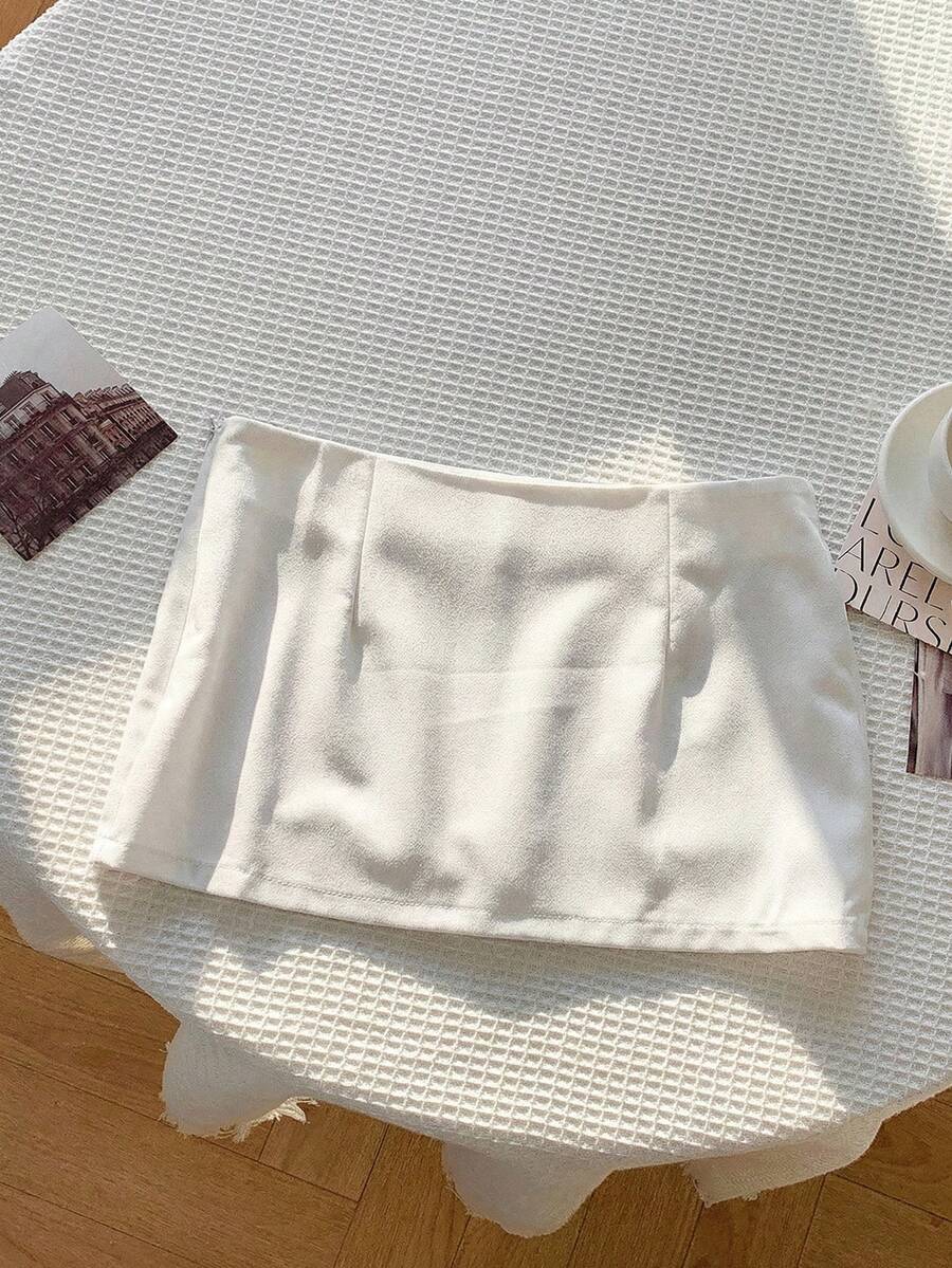 Women's white 100% cotton low waist mini skirt featuring a tropical print and zipper detail.