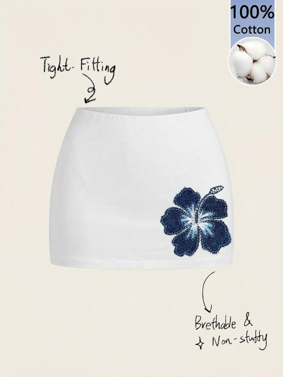 Women's white 100% cotton low waist mini skirt featuring a tropical print and zipper detail.