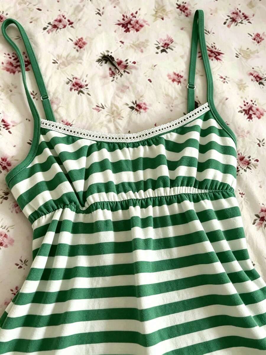 A women's black striped camisole top featuring spaghetti straps, a backless design with ring detail, and high-stretch knitted fabric.