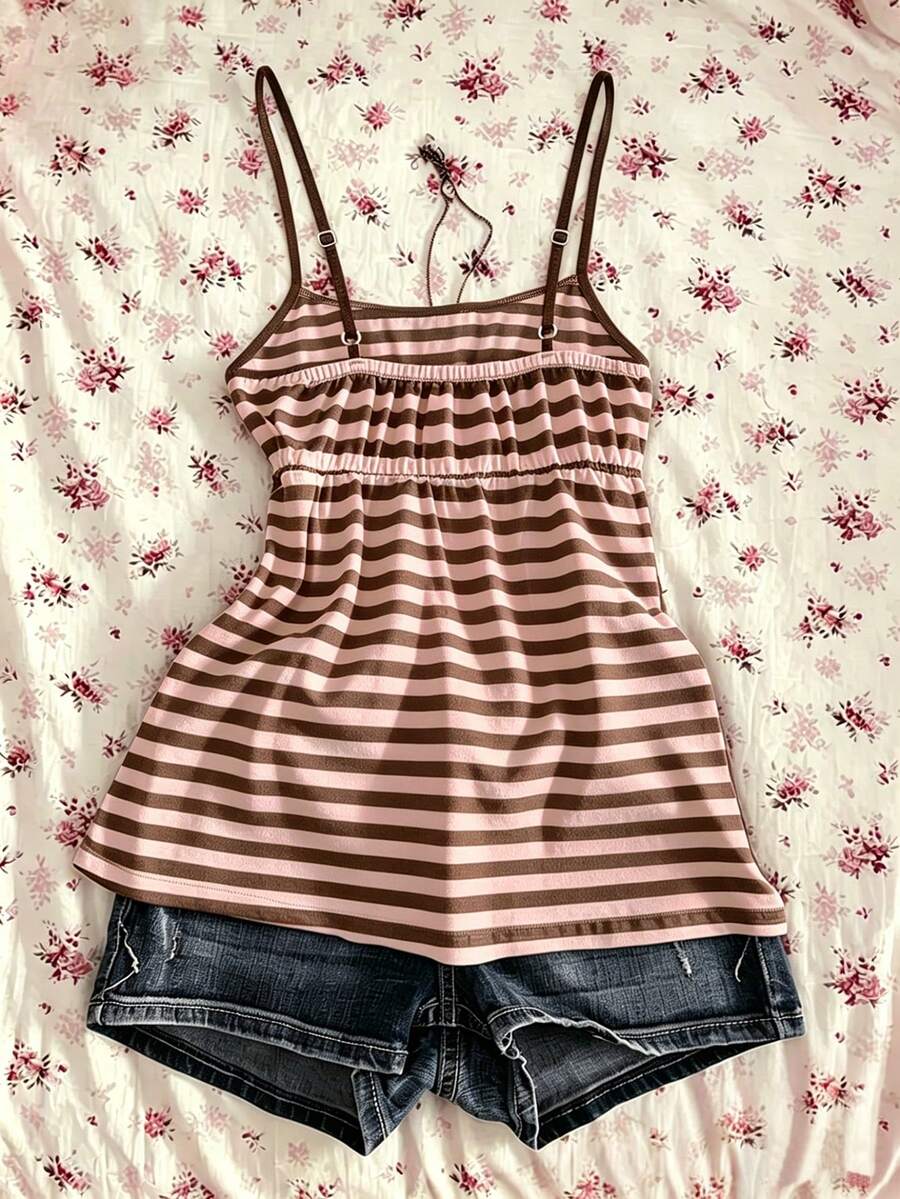 A women's black striped camisole top featuring spaghetti straps, a backless design with ring detail, and high-stretch knitted fabric.