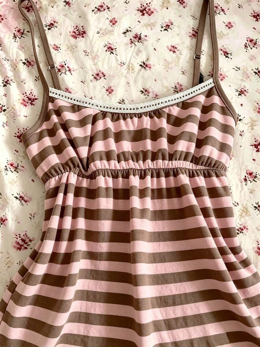 A women's black striped camisole top featuring spaghetti straps, a backless design with ring detail, and high-stretch knitted fabric.