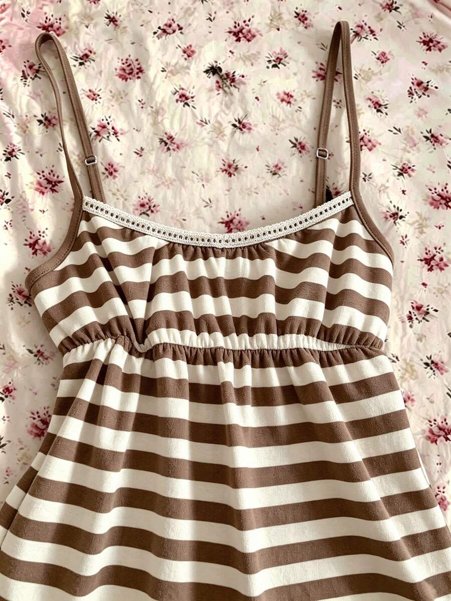 A women's black striped camisole top featuring spaghetti straps, a backless design with ring detail, and high-stretch knitted fabric.