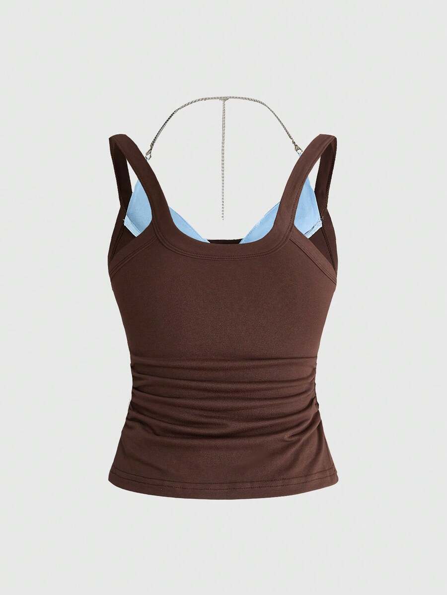 Backless grommet cami tank top featuring slim fit silhouette and strap details on knitted fabric