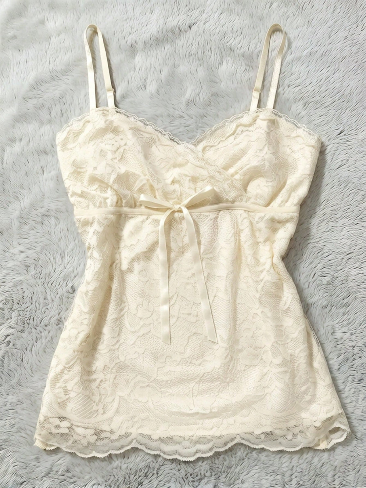 Women's solid color elegant lace cami top featuring contrast lace trim, cinched waist, spaghetti straps, and backless ring detail.