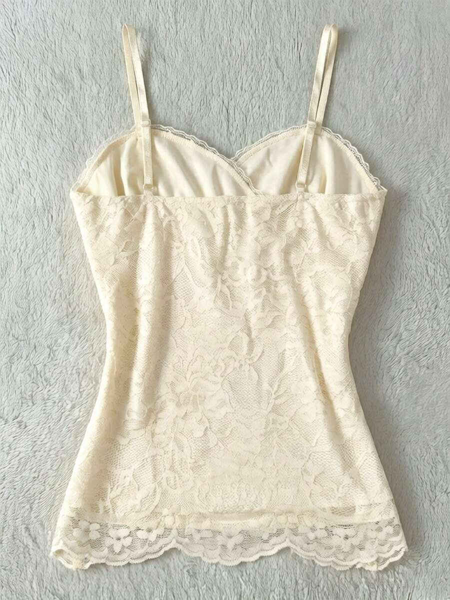Women's solid color elegant lace cami top featuring contrast lace trim, cinched waist, spaghetti straps, and backless ring detail.