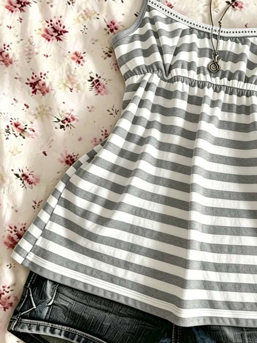 A women's black striped camisole top featuring spaghetti straps, a backless design with ring detail, and high-stretch knitted fabric.