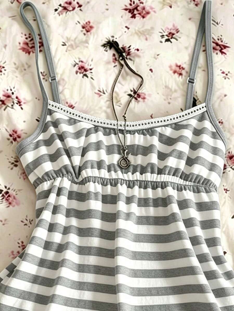 A women's black striped camisole top featuring spaghetti straps, a backless design with ring detail, and high-stretch knitted fabric.