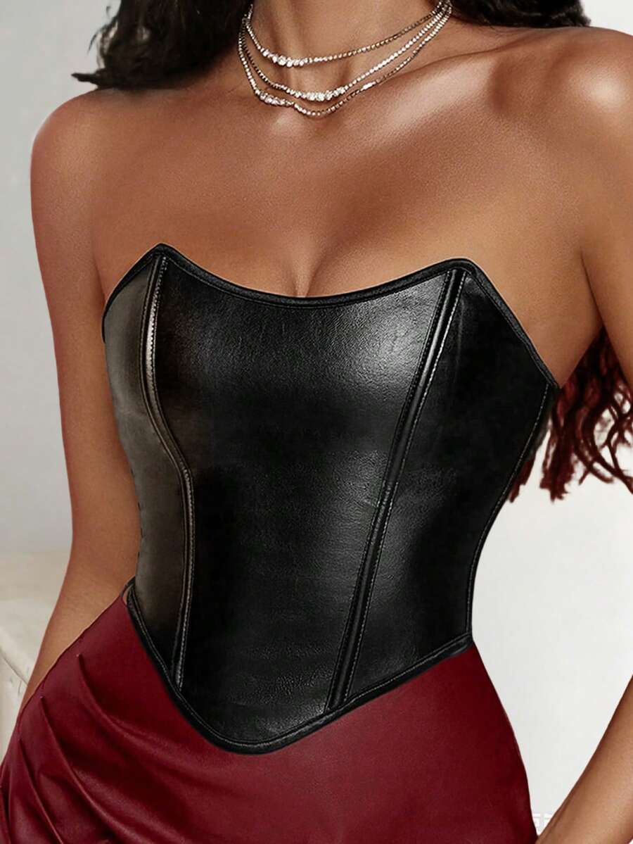 Women's black strapless PU bustier crop top featuring a lace-up back, grommet eyelet details, and an asymmetrical handkerchief hem.