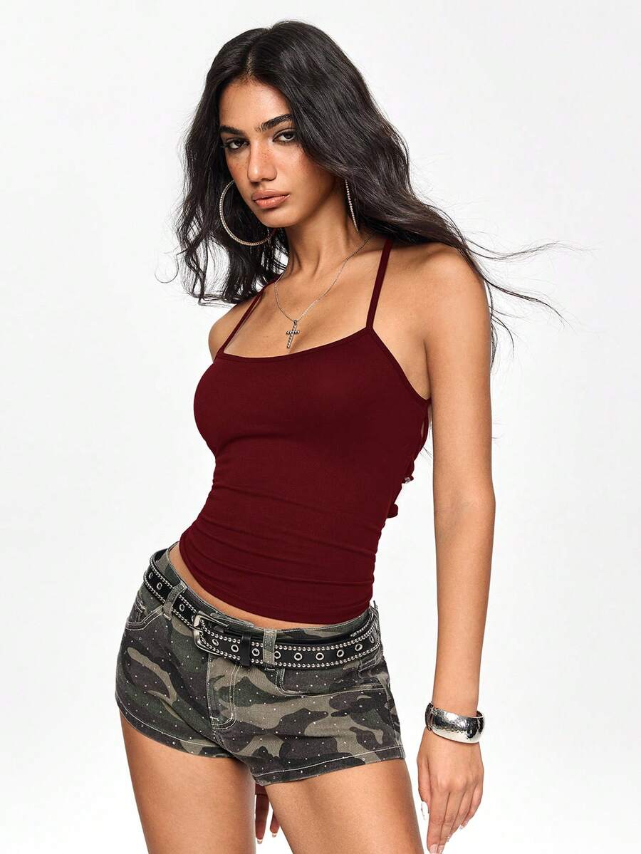 Women's white backless lace-up camisole top featuring spaghetti straps, criss-cross back details, asymmetrical hem, and matching arm sleeves.