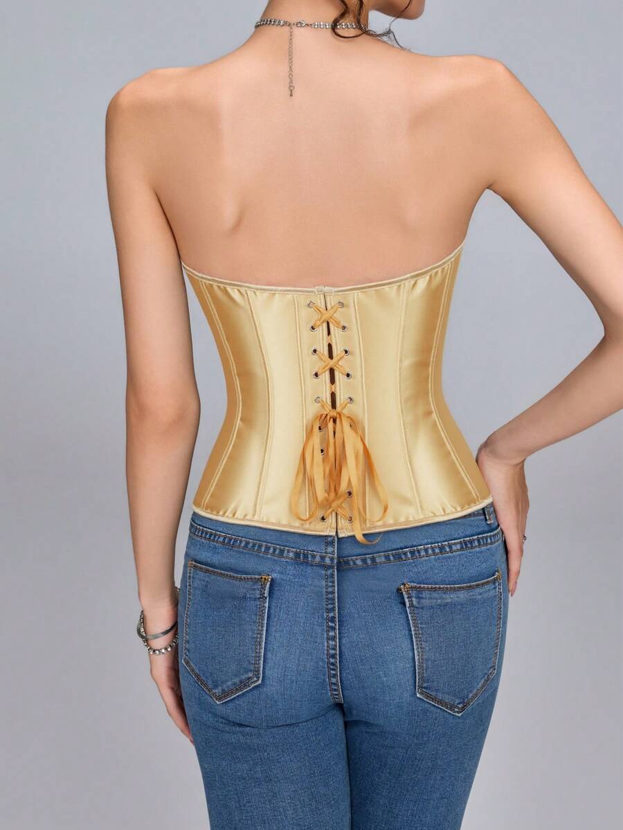 Blue satin bustier corset with front closure, back lace-up detail, and boned shaping for a retro-inspired party look.