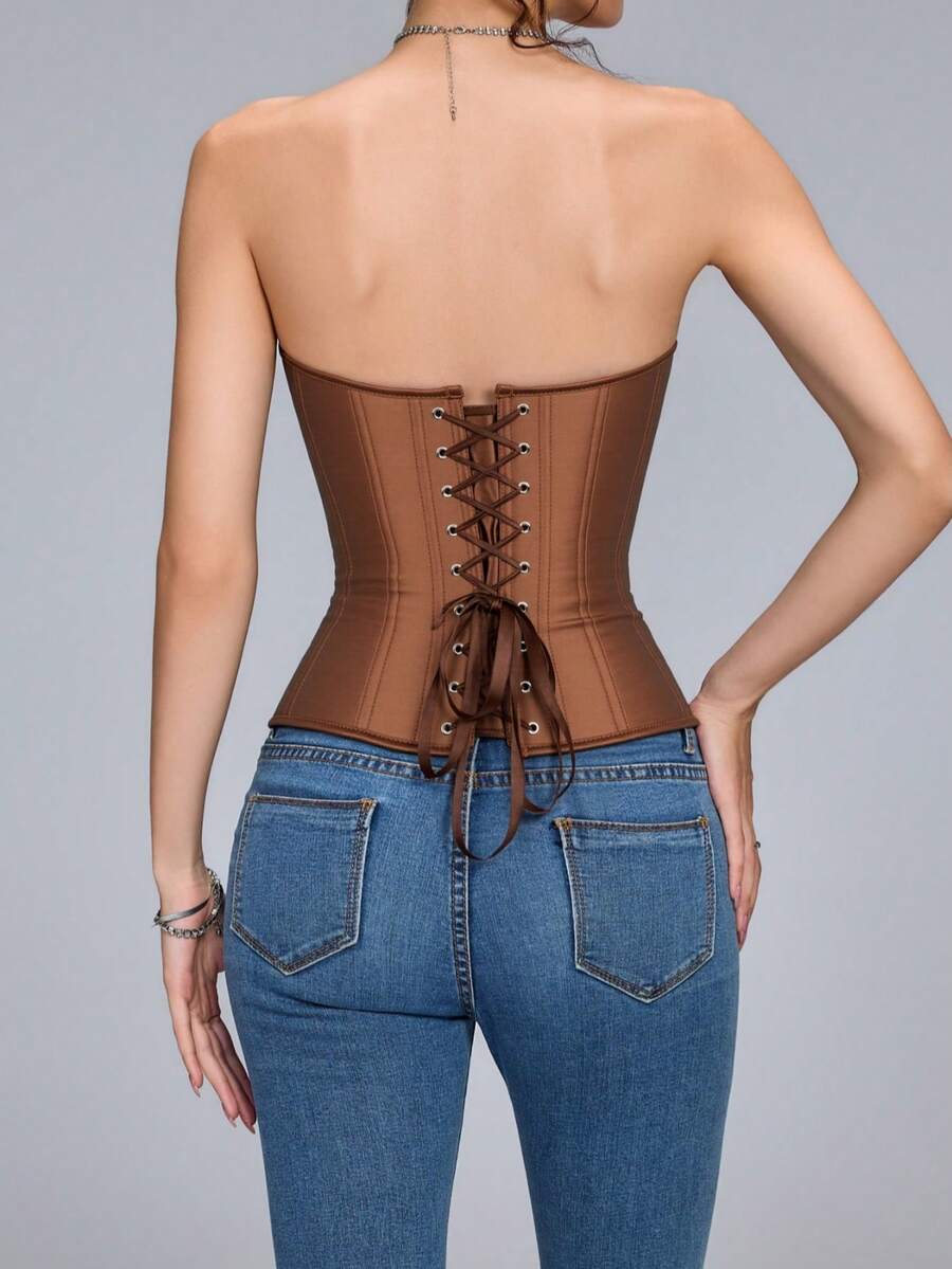 Blue satin bustier corset with front closure, back lace-up detail, and boned shaping for a retro-inspired party look.