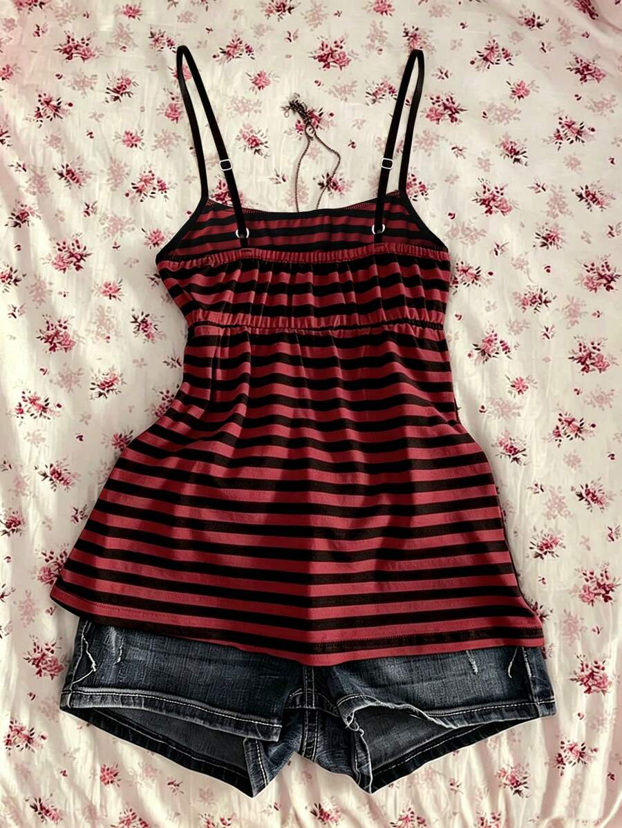 A women's black striped camisole top featuring spaghetti straps, a backless design with ring detail, and high-stretch knitted fabric.