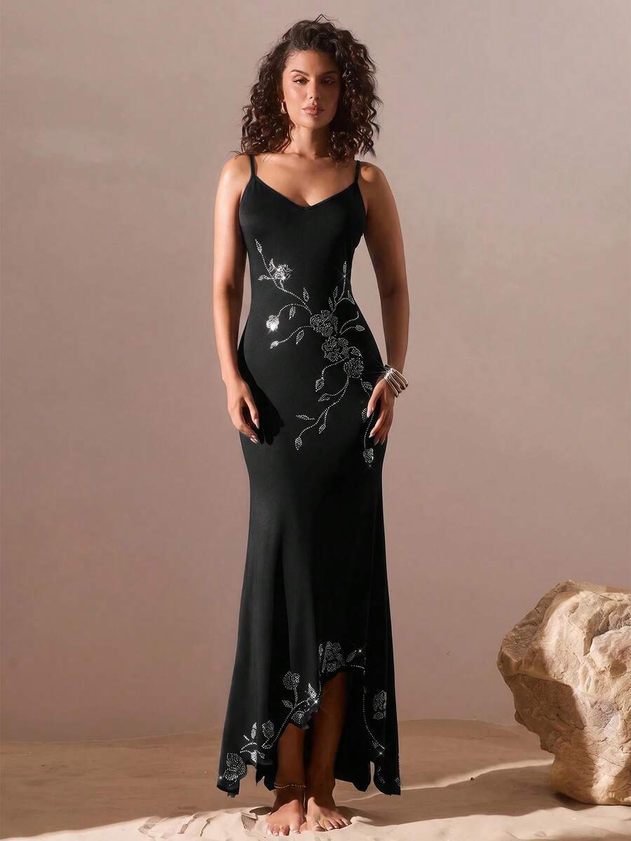 Black sleeveless asymmetrical cami maxi dress for women featuring spaghetti straps, 3D rose accent, arm sleeves, and a slim fit knitted design.