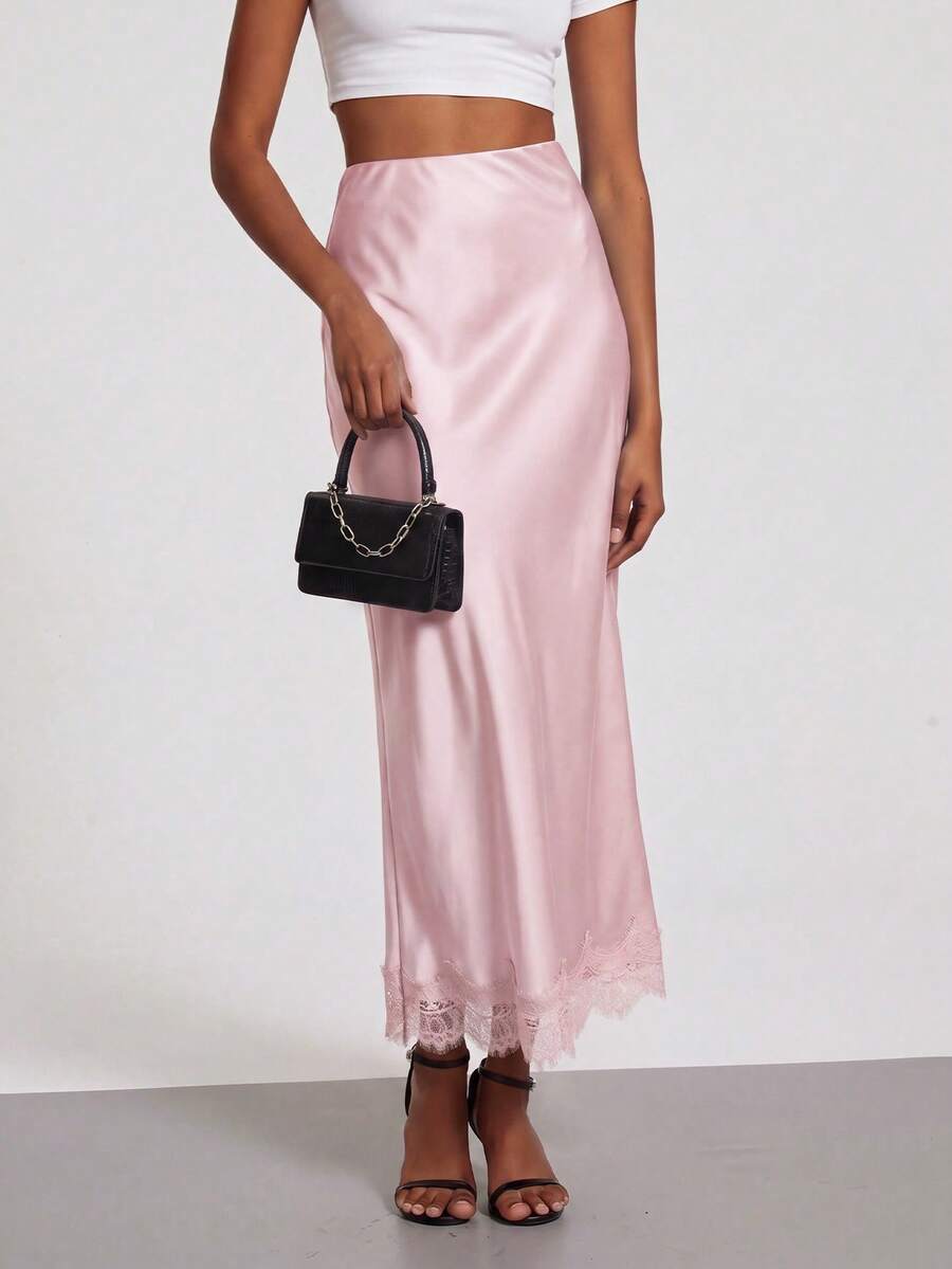 Women's black lace patchwork satin skirt featuring a long bodycon silhouette and natural mid waist design.