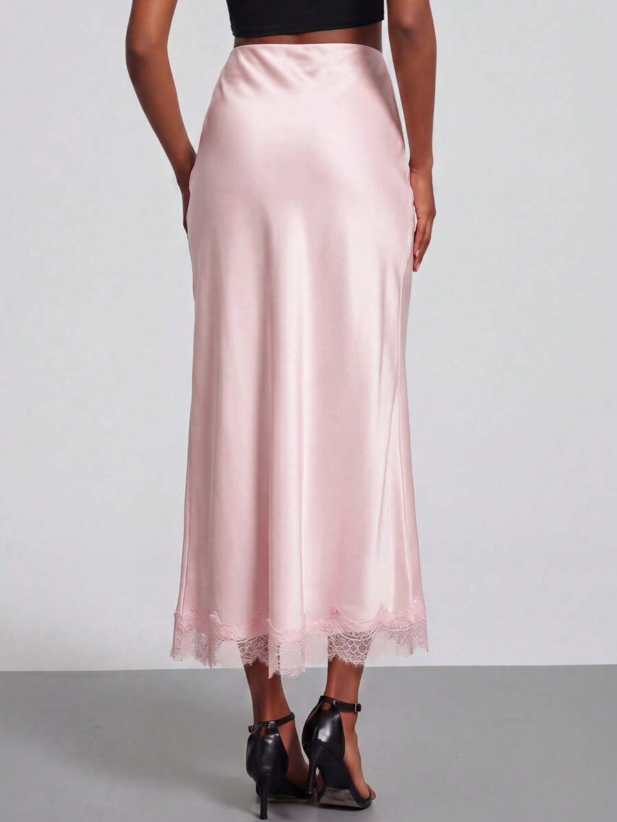 Women's black lace patchwork satin skirt featuring a long bodycon silhouette and natural mid waist design.