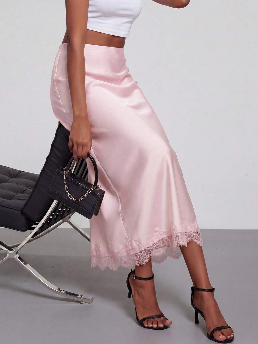 Women's black lace patchwork satin skirt featuring a long bodycon silhouette and natural mid waist design.