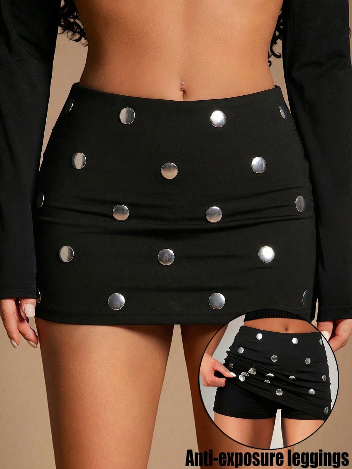 Women's black bodycon mini skort featuring a low waist, pleated side split hem, zipper closure, and built-in shorts.