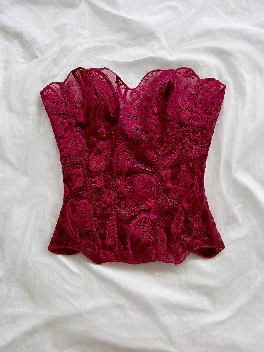 Strapless floral corset top with lace-up detail, asymmetrical hem, and slim fit for women in a boho vacation style.