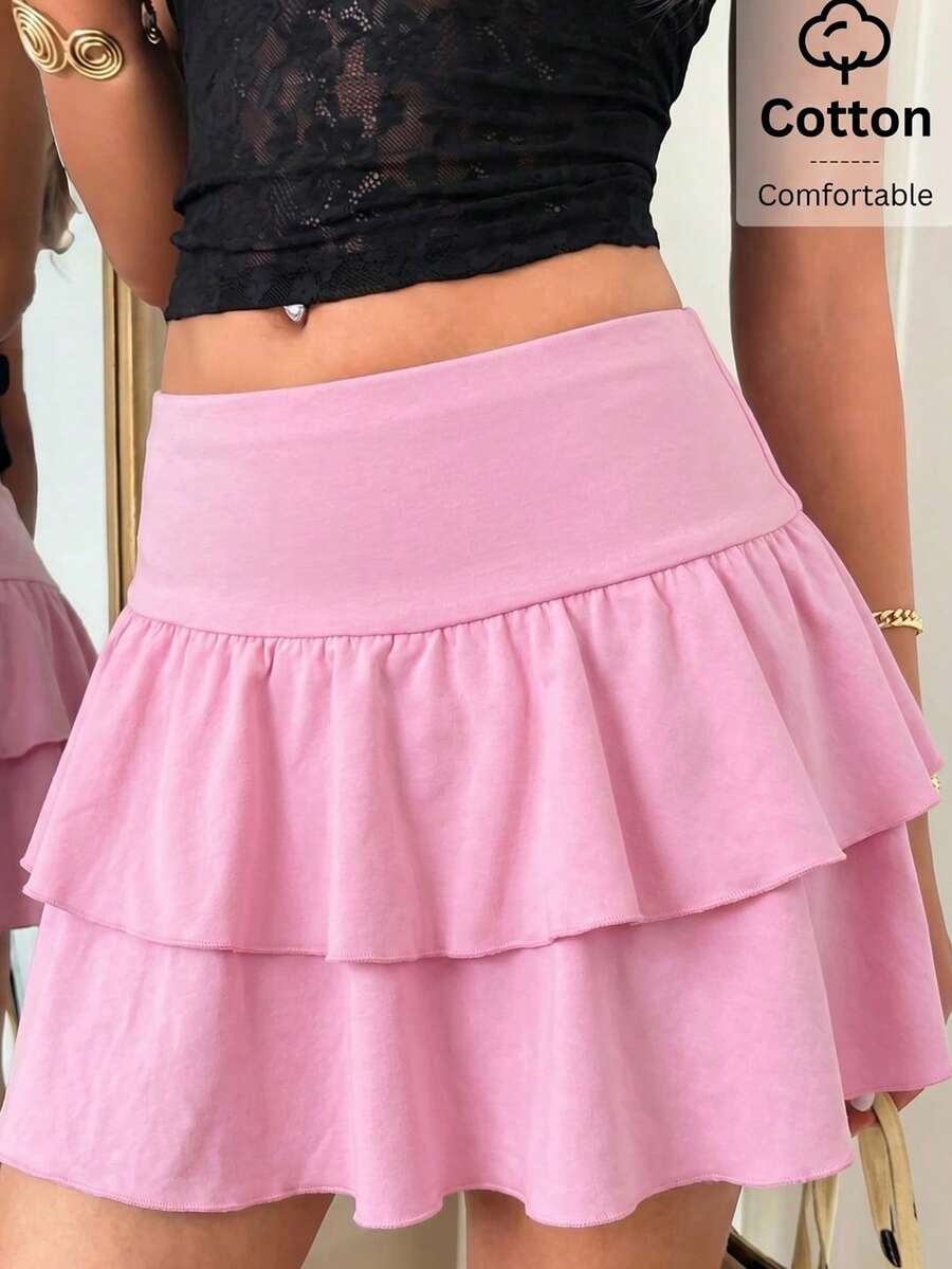 Black low waist knit mini skirt featuring a tiered ruffle hem and skinny high stretch fit.