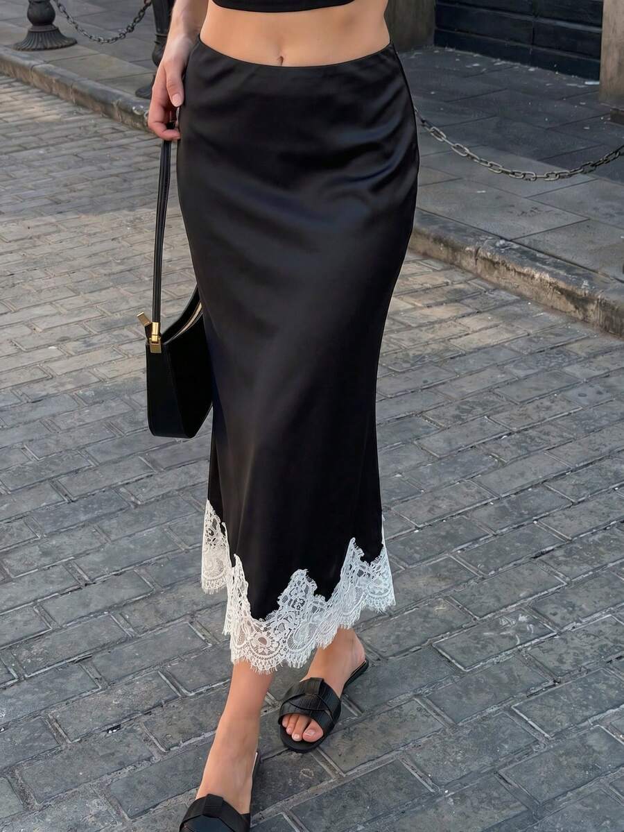 Women's apricot satin flared long skirt featuring contrast lace details, hollow out accents, polka dot pattern, and a low waist regular fit.