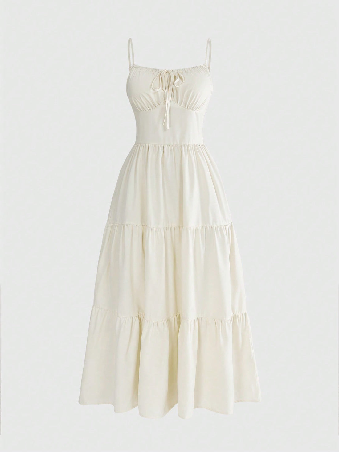 Women wearing a solid color boho spaghetti strap long dress with a ruched bust, high waist, and tiered ruffle hem.
